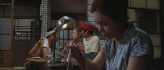 Figure 6- The mother is left in front of the camera obstructing the conversation in the background.